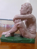 sitting man, can be used as book holder on a shelve